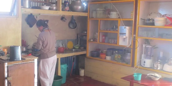 Water must be hand-carried to REC's upstairs kitchen. The sink has no faucets because there is no hot or cold running water.  The wooden box in the foreground is a metal-lined & charcoal-fired wooden oven.  Also, the kitchen has no freezer and no refrigeration.